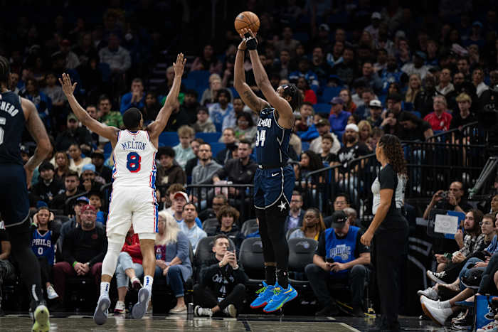 Wendell Carter Jr. (34) of the Orlando Magic takes a three-pointer over De'Anthony Melton (8) of the Philadelphia 76ers.